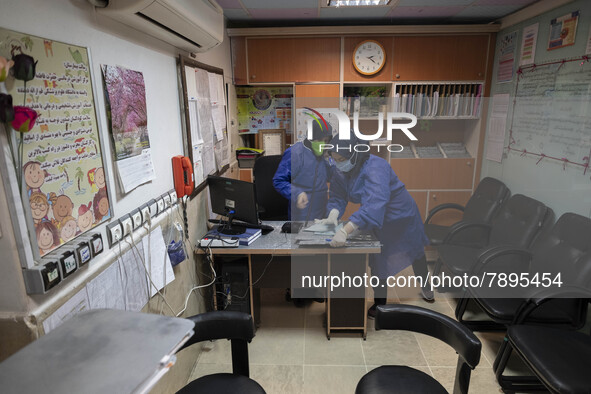 Two Iranian nurses wearing protective suits work at a COVID-19 ward in a children hospital in the holy city of Qom 145Km (90 miles) south of...