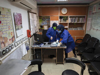 Two Iranian nurses wearing protective suits work at a COVID-19 ward in a children hospital in the holy city of Qom 145Km (90 miles) south of...