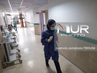 An Iranian nurse wearing a protective suit walks along a corridor at a COVID-19 ward in a children hospital in the holy city of Qom 145Km (9...