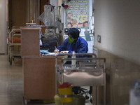 An Iranian nurse wearing a protective suit works at a COVID-19 ward in a children hospital in the holy city of Qom 145Km (90 miles) south of...