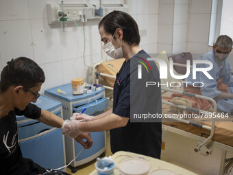 An Iranian nurse wearing a protective suit attends to a patient at a COVID-19 ward in a hospital in the holy city of Qom 145Km (90 miles) so...