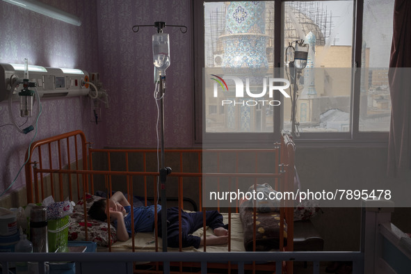 An Iranian 9-year-old boy with autism who is infected by COVID-19 as well, lies on a hospital bed at a new coronavirus disease ward in a chi...