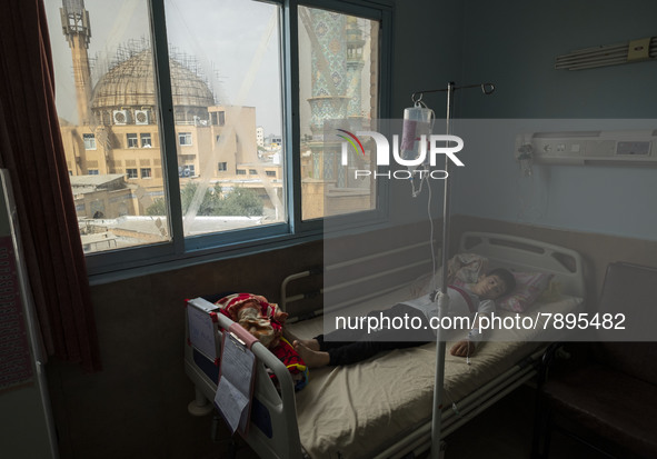 An Iranian 9-year-old boy who is infected by COVID-19 lies on a hospital bed at a new coronavirus disease ward in a children hospital in the...