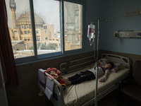 An Iranian 9-year-old boy who is infected by COVID-19 lies on a hospital bed at a new coronavirus disease ward in a children hospital in the...