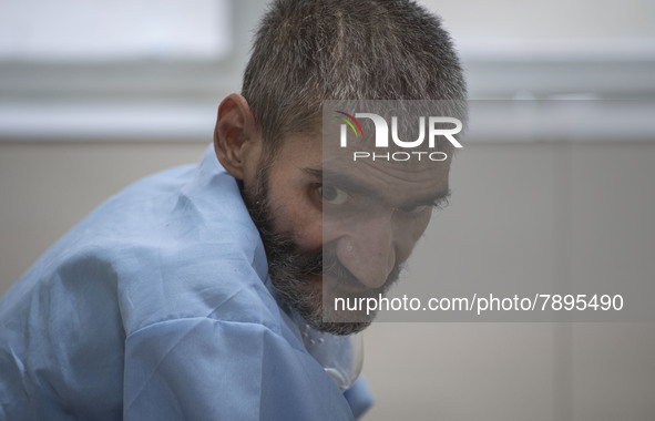 An Iranian elderly man who is infected by COVID-19 looks on as he sits on a hospital bed at a COVID-19 ward in a hospital in the holy city o...