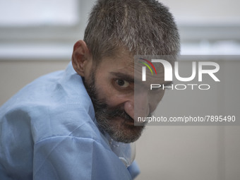 An Iranian elderly man who is infected by COVID-19 looks on as he sits on a hospital bed at a COVID-19 ward in a hospital in the holy city o...