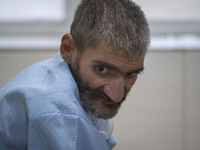 An Iranian elderly man who is infected by COVID-19 looks on as he sits on a hospital bed at a COVID-19 ward in a hospital in the holy city o...