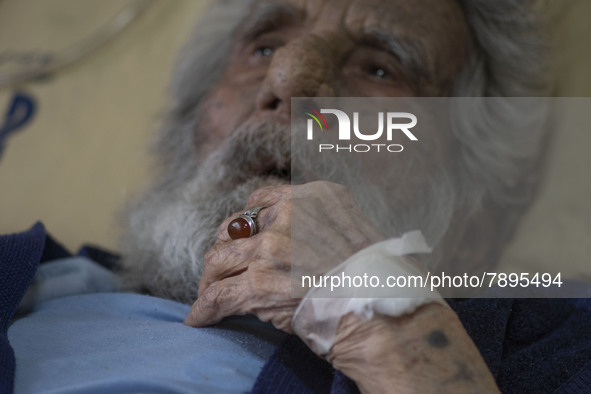 An Iranian man who is infected by COVID-19 looks on as he lies on a hospital bed at a COVID-19 ward in a hospital in the holy city of Qom 14...