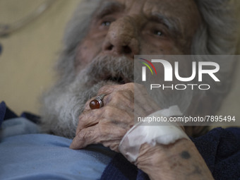 An Iranian man who is infected by COVID-19 looks on as he lies on a hospital bed at a COVID-19 ward in a hospital in the holy city of Qom 14...