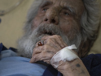 An Iranian man who is infected by COVID-19 looks on as he lies on a hospital bed at a COVID-19 ward in a hospital in the holy city of Qom 14...