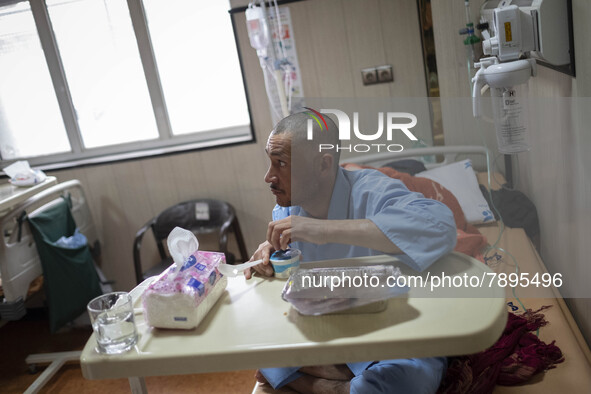 An Iranian man who is infected by COVID-19 looks on as he sits on a hospital bed at a COVID-19 ward in a hospital in the holy city of Qom 14...