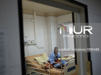 An Iranian elderly man who is infected by COVID-19 sits on a hospital bed at a COVID-19 ward in a hospital in the holy city of Qom 145Km (90...