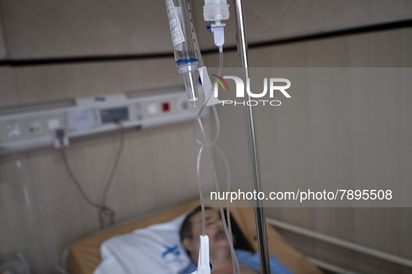 An Iranian man who is infected by COVID-19 lies on a hospital bed at a COVID-19 ward in a hospital in the holy city of Qom 145Km (90 miles)...