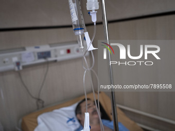 An Iranian man who is infected by COVID-19 lies on a hospital bed at a COVID-19 ward in a hospital in the holy city of Qom 145Km (90 miles)...