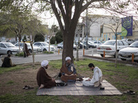 Clerics study religious lessons while sitting on a street-side in the holy city of Qom 145Km (90 miles) south of Tehran on March 10, 2022. (