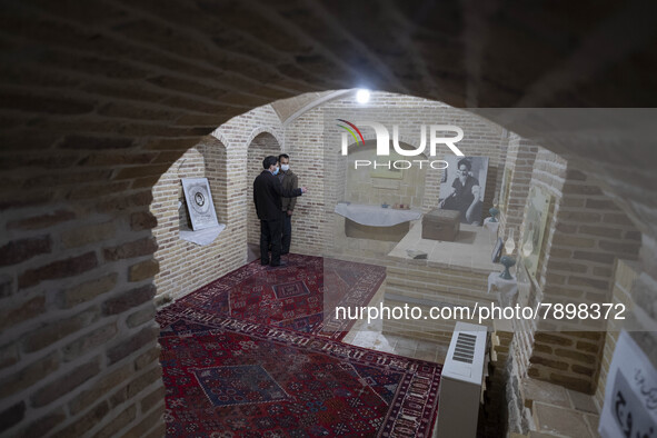 Two Iranian men talk to each other while visiting the house of Ayatollah Ruhollah Khomeini, founder and first spiritual leader of the Islami...