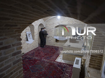 Two Iranian men talk to each other while visiting the house of Ayatollah Ruhollah Khomeini, founder and first spiritual leader of the Islami...