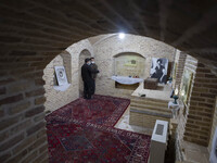 Two Iranian men talk to each other while visiting the house of Ayatollah Ruhollah Khomeini, founder and first spiritual leader of the Islami...