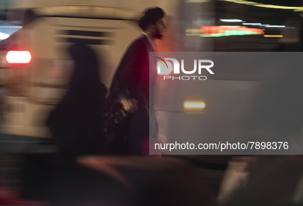 An Iranian cleric walks along an avenue in the holy city of Qom 145Km (90 miles) south of Tehran at night on March 10, 2022. 