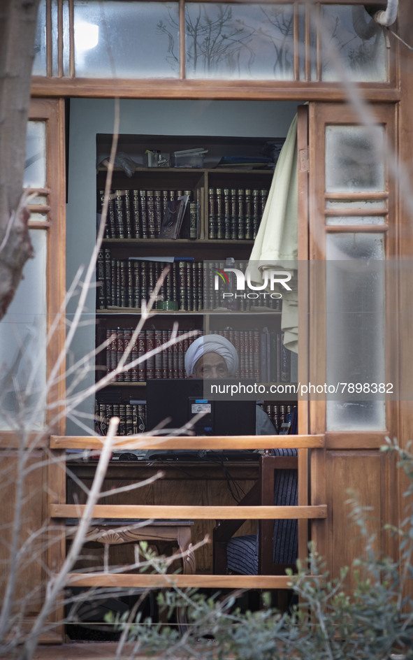 An Iranian cleric sits behind a computer display at a room in the house of Ayatollah Ruhollah Khomeini, founder and first spiritual leader o...