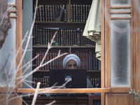 An Iranian cleric sits behind a computer display at a room in the house of Ayatollah Ruhollah Khomeini, founder and first spiritual leader o...