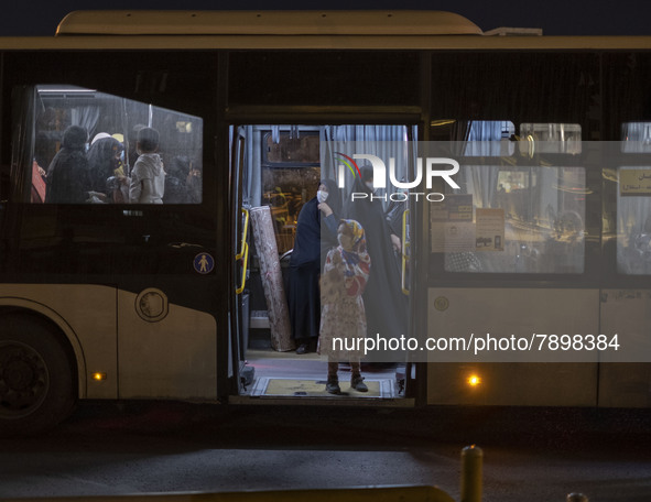 Iranian veiled women stand at a bus near a holy shrine after evening prayer ceremony in the holy city of Qom 145Km (90 miles) south of Tehra...