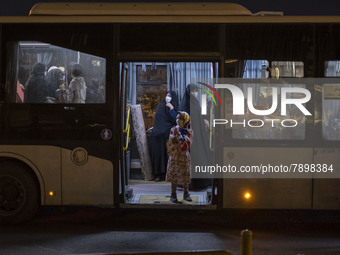 Iranian veiled women stand at a bus near a holy shrine after evening prayer ceremony in the holy city of Qom 145Km (90 miles) south of Tehra...