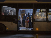 Iranian veiled women stand at a bus near a holy shrine after evening prayer ceremony in the holy city of Qom 145Km (90 miles) south of Tehra...