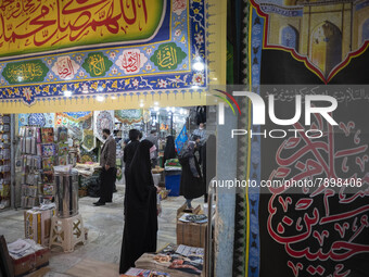 An Iranian veiled woman stands next to religious flag while shopping in a religious shopping center in the holy city of Qom 145Km (90 miles)...