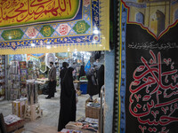 An Iranian veiled woman stands next to religious flag while shopping in a religious shopping center in the holy city of Qom 145Km (90 miles)...