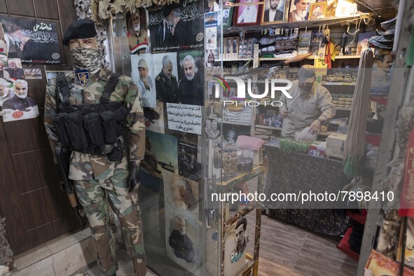 A mannequin decorated with an Islamic Revolutionary Guard Corps (IRGC) military uniform next to the portraits of the former commander of IRG...