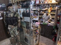 A mannequin decorated with an Islamic Revolutionary Guard Corps (IRGC) military uniform next to the portraits of the former commander of IRG...