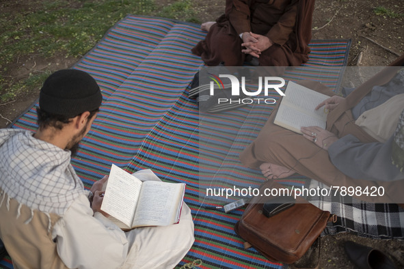 Clerics study religious lessons while sitting on a street-side in the holy city of Qom 145Km (90 miles) south of Tehran on March 10, 2022. 