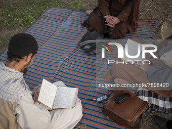 Clerics study religious lessons while sitting on a street-side in the holy city of Qom 145Km (90 miles) south of Tehran on March 10, 2022. (