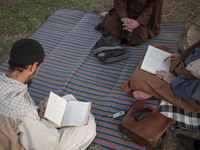 Clerics study religious lessons while sitting on a street-side in the holy city of Qom 145Km (90 miles) south of Tehran on March 10, 2022. (