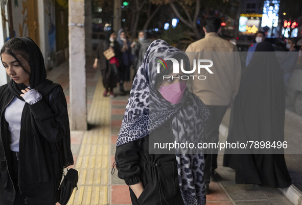 Two Iranian young women walk along an avenue in the holy city of Qom 145Km (90 miles) south of Tehran on March 10, 2022. 