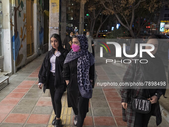 Iranian young women walk along an avenue in the holy city of Qom 145Km (90 miles) south of Tehran on March 10, 2022. (