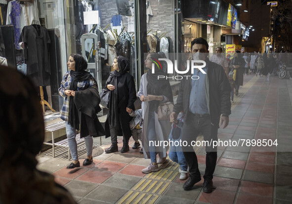 Iranian women look at a shop window while walking along a street-side in the holy city of Qom145Km (90 miles) south of Tehran on March 10, 2...