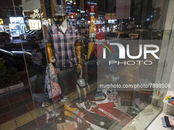 An Iranian young woman looks at a shop window in the holy city of Qom145Km (90 miles) south of Tehran on March 10, 2022. (