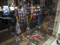 An Iranian young woman looks at a shop window in the holy city of Qom145Km (90 miles) south of Tehran on March 10, 2022. (