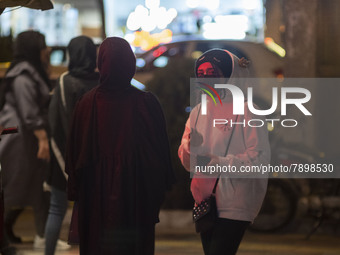 An Iranian young girl wearing a protective face mask looks on while standing out of a fast-food restaurant in the holy city of Qom 145Km (90...