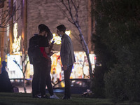 Iranian youths stand together as they check their pages on Social Media platforms on their smartphones at a square in the holy city of Qom 1...