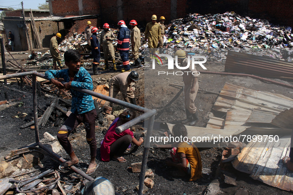 People search for their belongings as firemen lay a hose pipe across damaged shanties after a fire broke out in a makeshift settlement area...