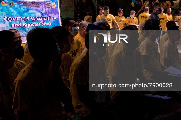 Filipino inmates wait to get their shots of AstraZeneca’s COVID19 vaccine inside the Quezon City Jail in Metro Manila, Philippines on 12 Mar...