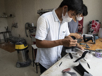 Dare.id employees are finishing the prosthesis.  COKI TOBING, the owner of a prosthetic limb and assistive device for people with cerebral p...