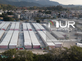  A view by drone of the San Tin Community Isolation Facility. On the right, new arrivals are surrounded by staff after getting down from the...