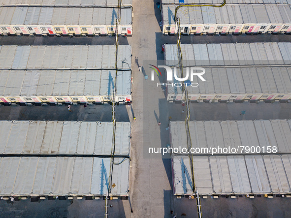  A view by drone of the San Tin Community Isolation Facility, with patients walking in the alleys and healthcare personnel in blue PPE, in H...