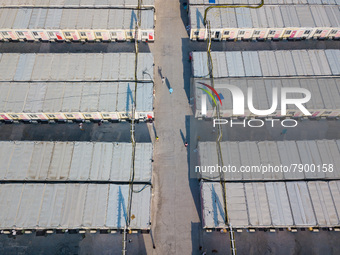  A view by drone of the San Tin Community Isolation Facility, with patients walking in the alleys and healthcare personnel in blue PPE, in H...