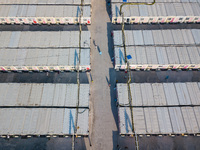  A view by drone of the San Tin Community Isolation Facility, with patients walking in the alleys and healthcare personnel in blue PPE, in H...