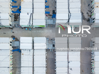  A drone view of the Tsing YI Community Isolation Facility, with staff in blue PPE sitting between the isolation blocks, in Hong Kong, China...